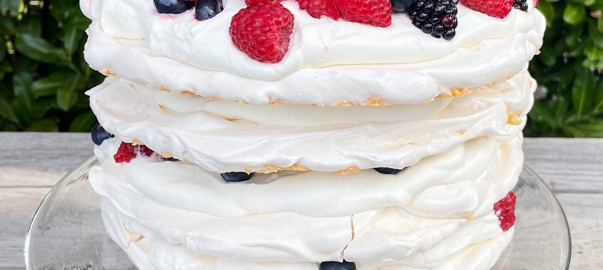 Pavlova with whipped cream and berries